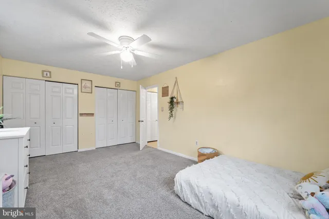 a view of a livingroom with a ceiling fan and window