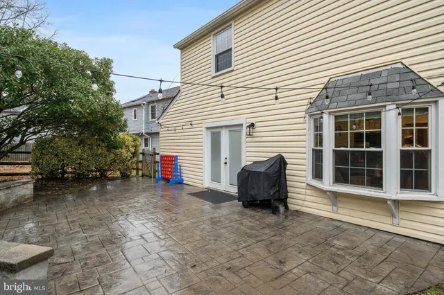 a view of a house with a backyard and a chair
