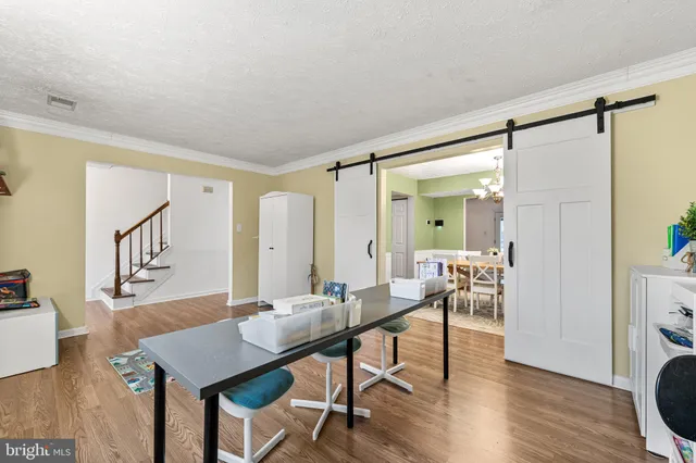 a view of a livingroom with furniture and wooden floor