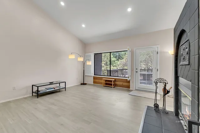 a kitchen with stainless steel appliances granite countertop a refrigerator a stove a sink a dining table and chairs