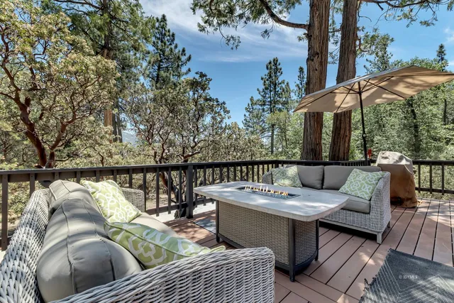 a view of staircase with lots of frames on wall and a window
