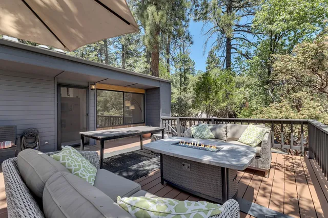 a dining room with furniture and a floor to ceiling window