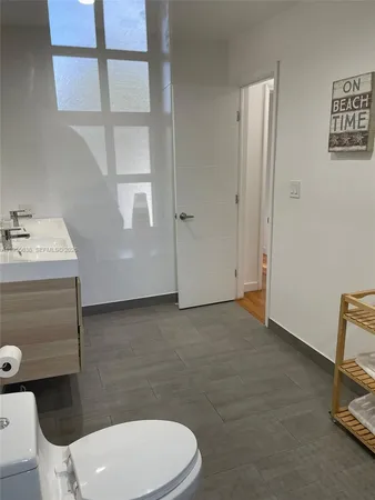 a bathroom with a sink a toilet and a mirror