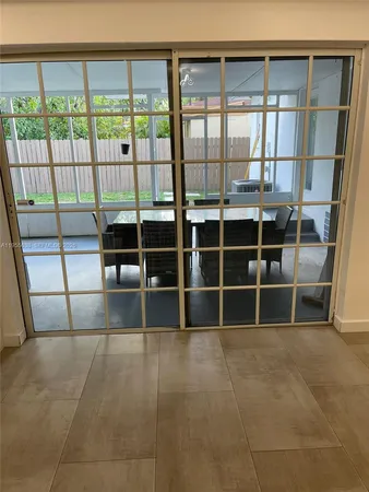 a view of a big room with an empty room and windows