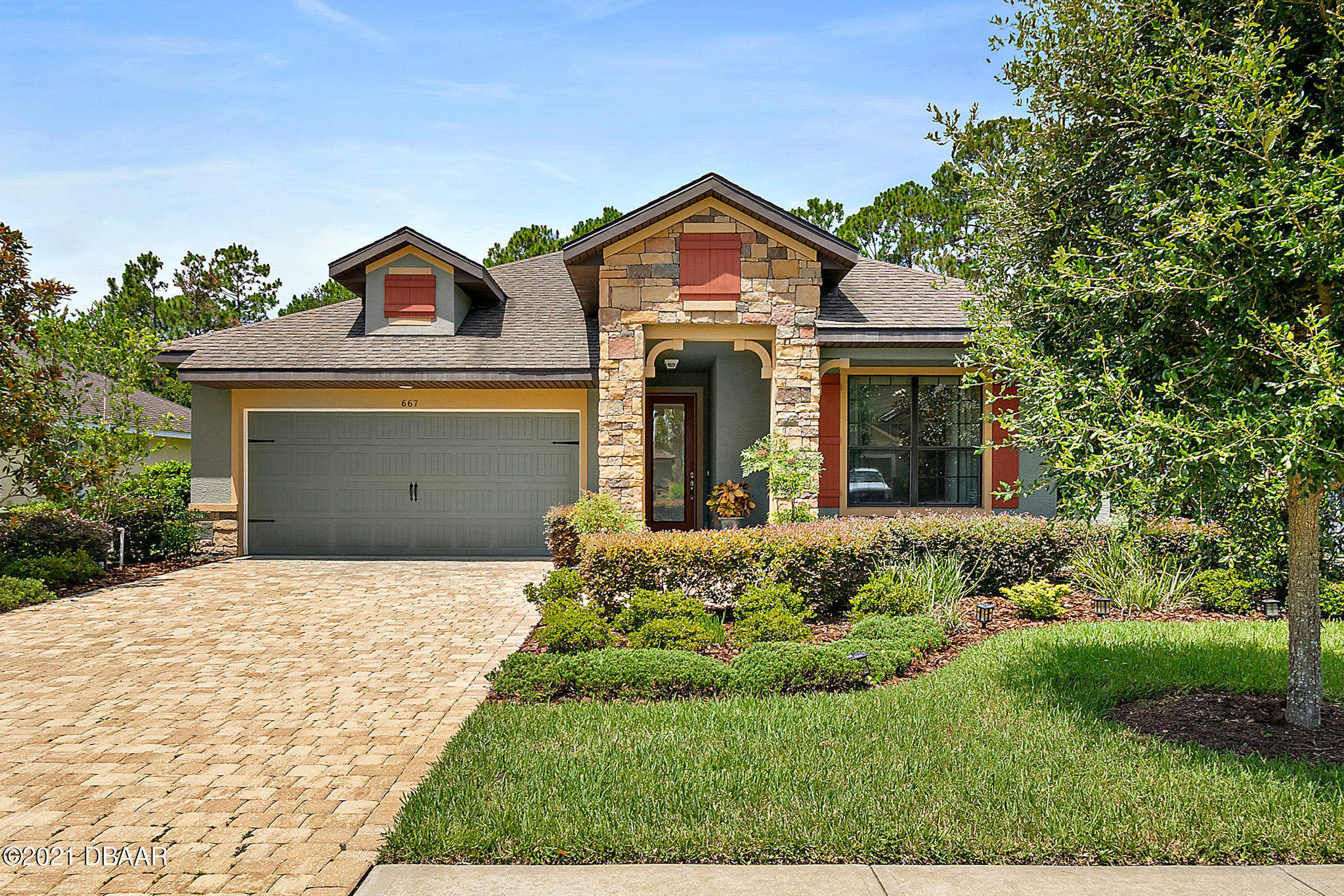 a front view of a house with a yard and garage