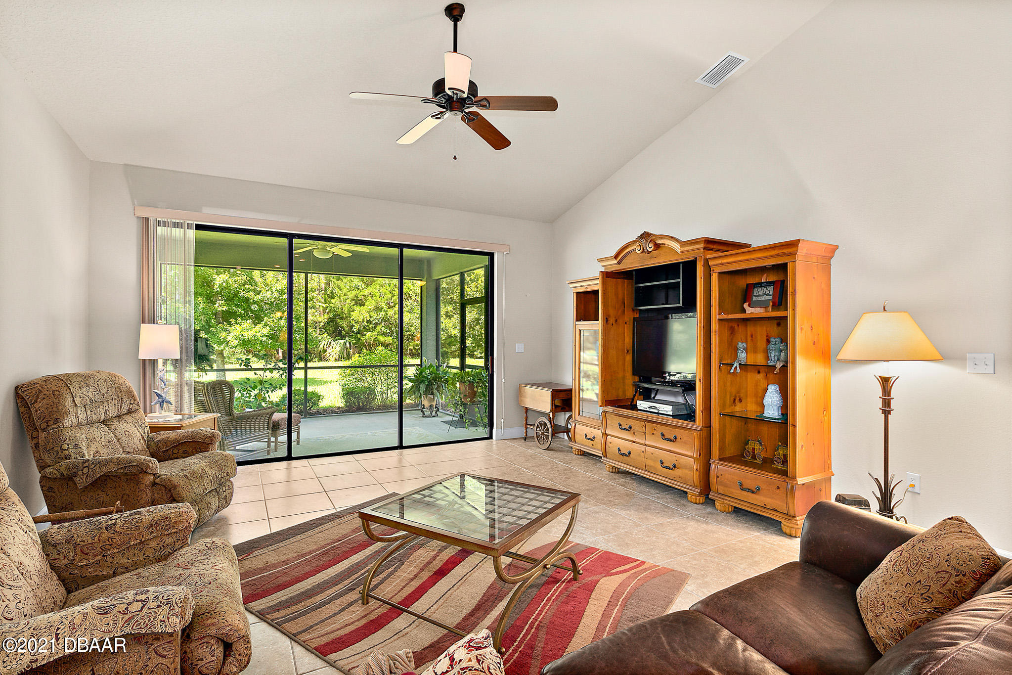 667 Elk River Drive Ormond Beach, FL 32174 - Photo 11 of 49 a living room with furniture and a floor to ceiling window