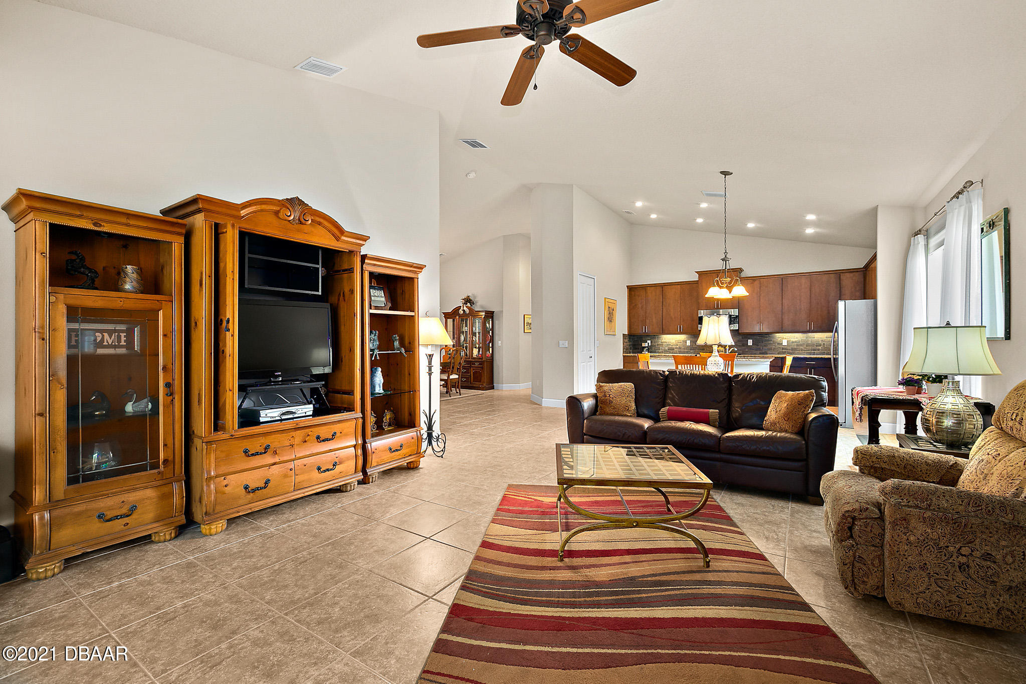 667 Elk River Drive Ormond Beach, FL 32174 - Photo 12 of 49 a living room with furniture and a flat screen tv