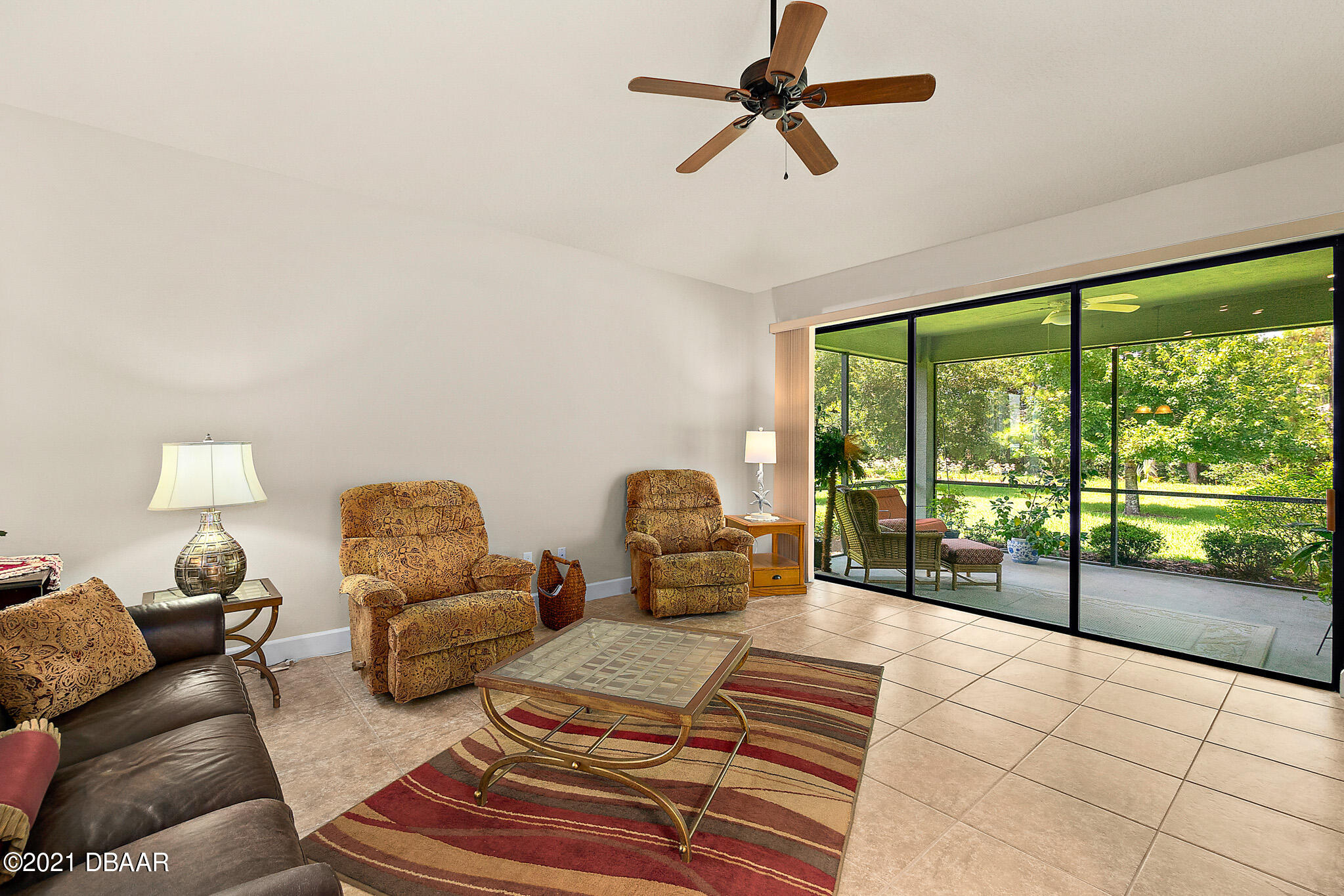 667 Elk River Drive Ormond Beach, FL 32174 - Photo 14 of 49 a living room with furniture and a floor to ceiling window