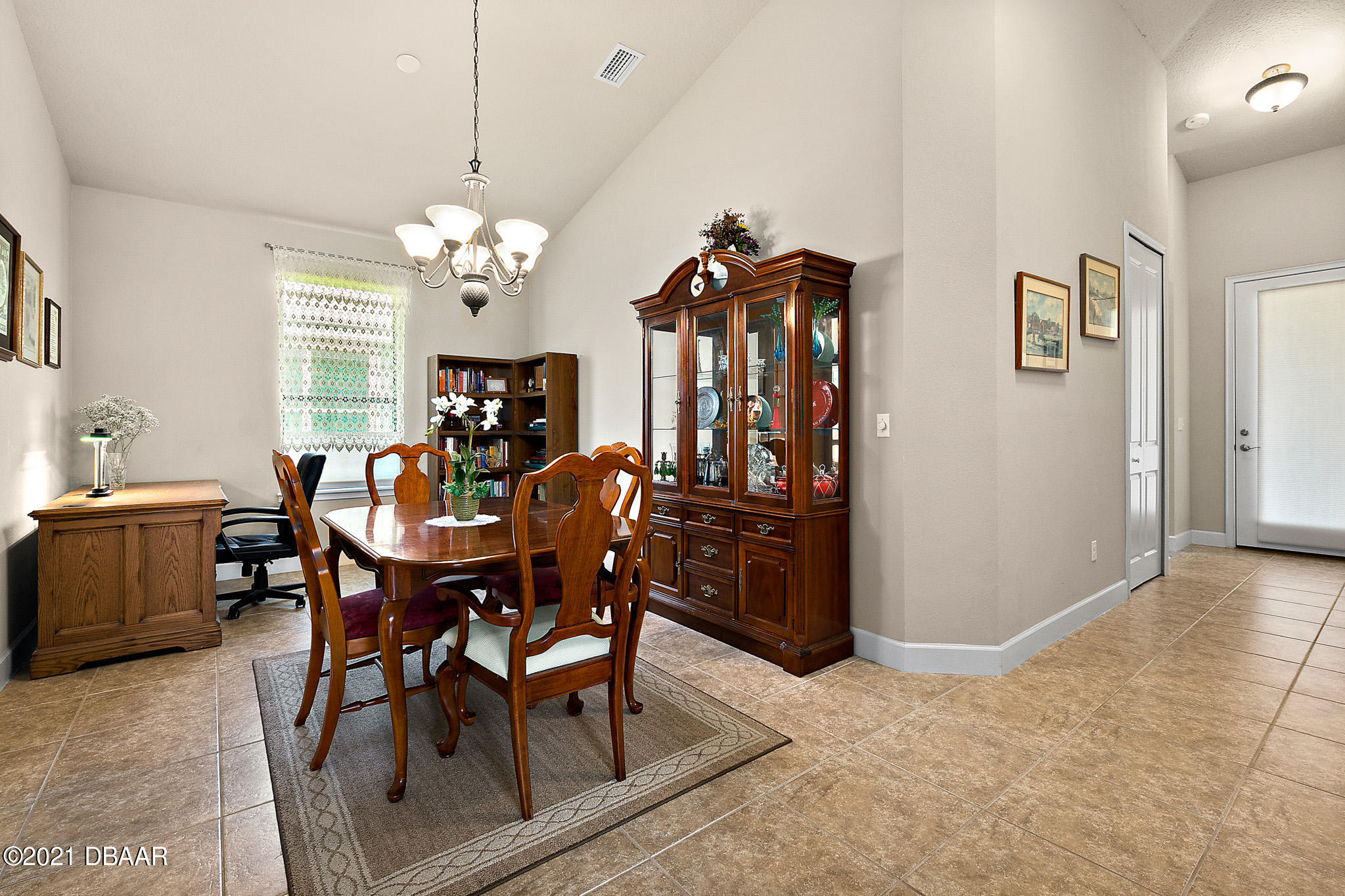 667 Elk River Drive Ormond Beach, FL 32174 - Photo 16 of 49 a view of a dining room with furniture and a chandelier
