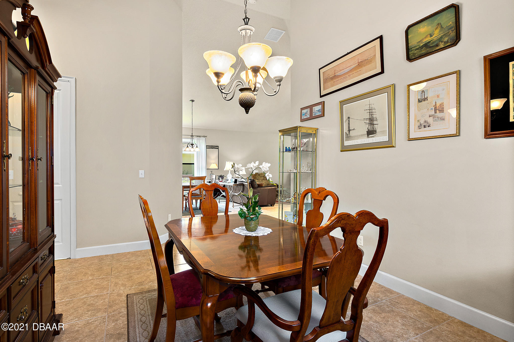 667 Elk River Drive Ormond Beach, FL 32174 - Photo 18 of 49 a dining room with furniture and chandelier
