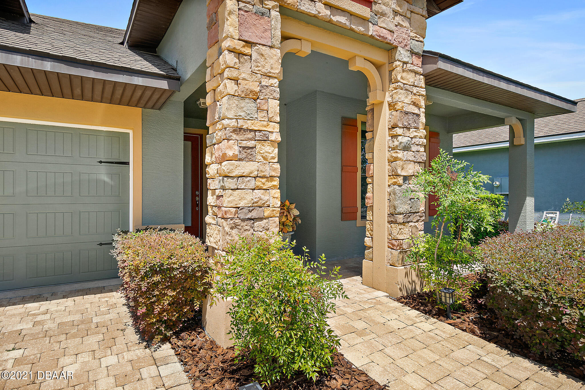 667 Elk River Drive Ormond Beach, FL 32174 - Photo 2 of 49 a view of yellow house with potted plants
