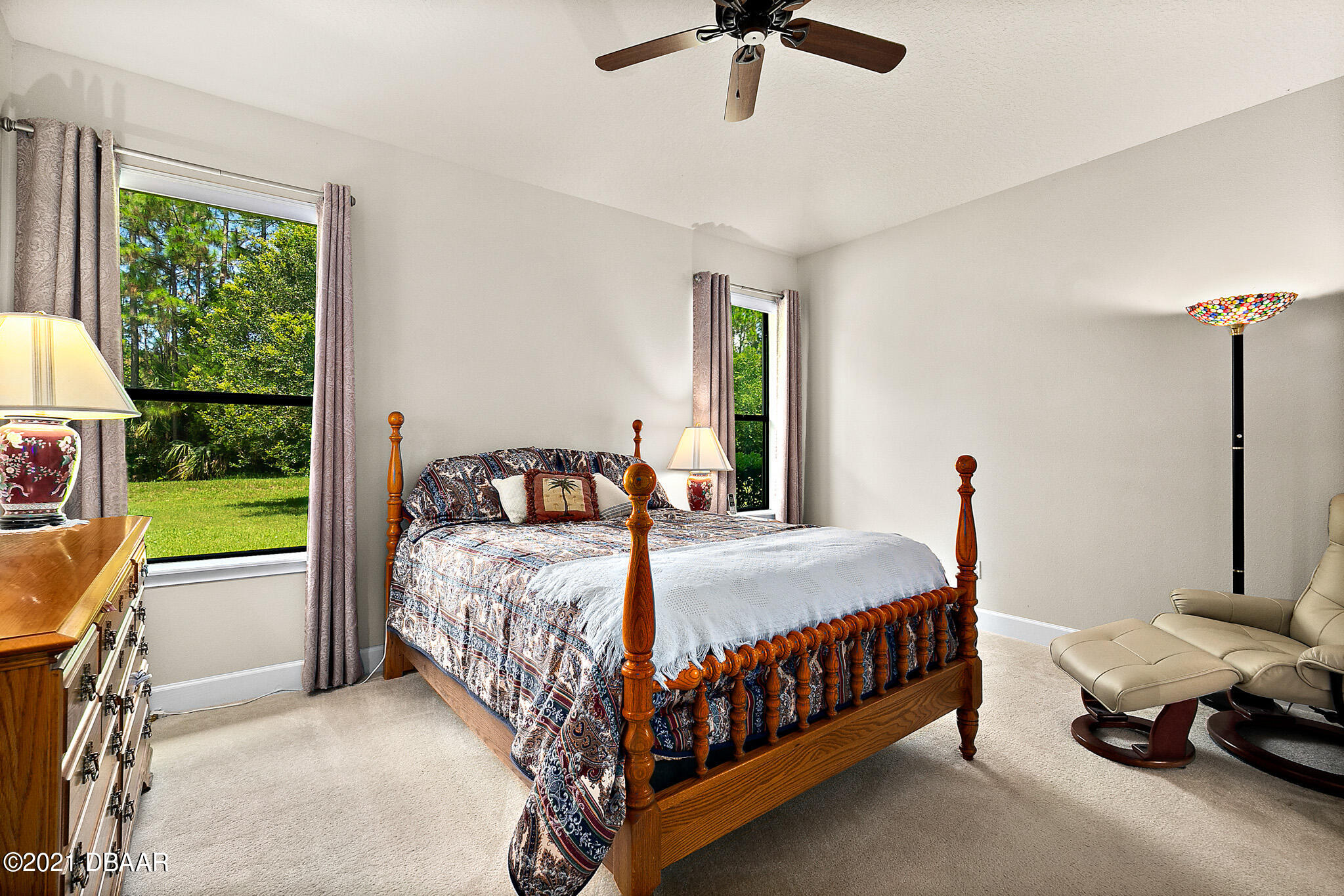 667 Elk River Drive Ormond Beach, FL 32174 - Photo 19 of 49 a bedroom with a bed chandelier and a window