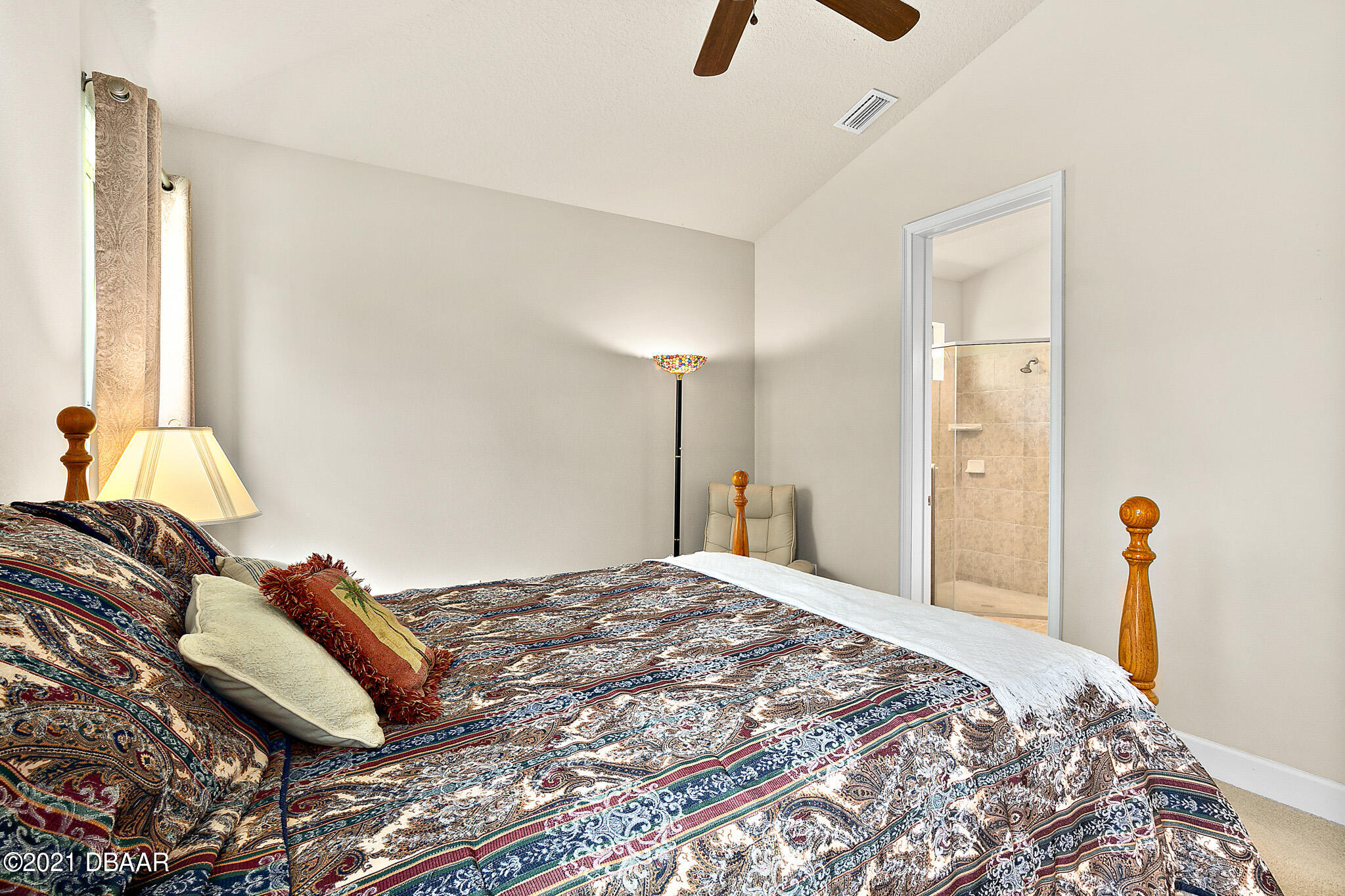 667 Elk River Drive Ormond Beach, FL 32174 - Photo 20 of 49 a bedroom with a bed and a lamp