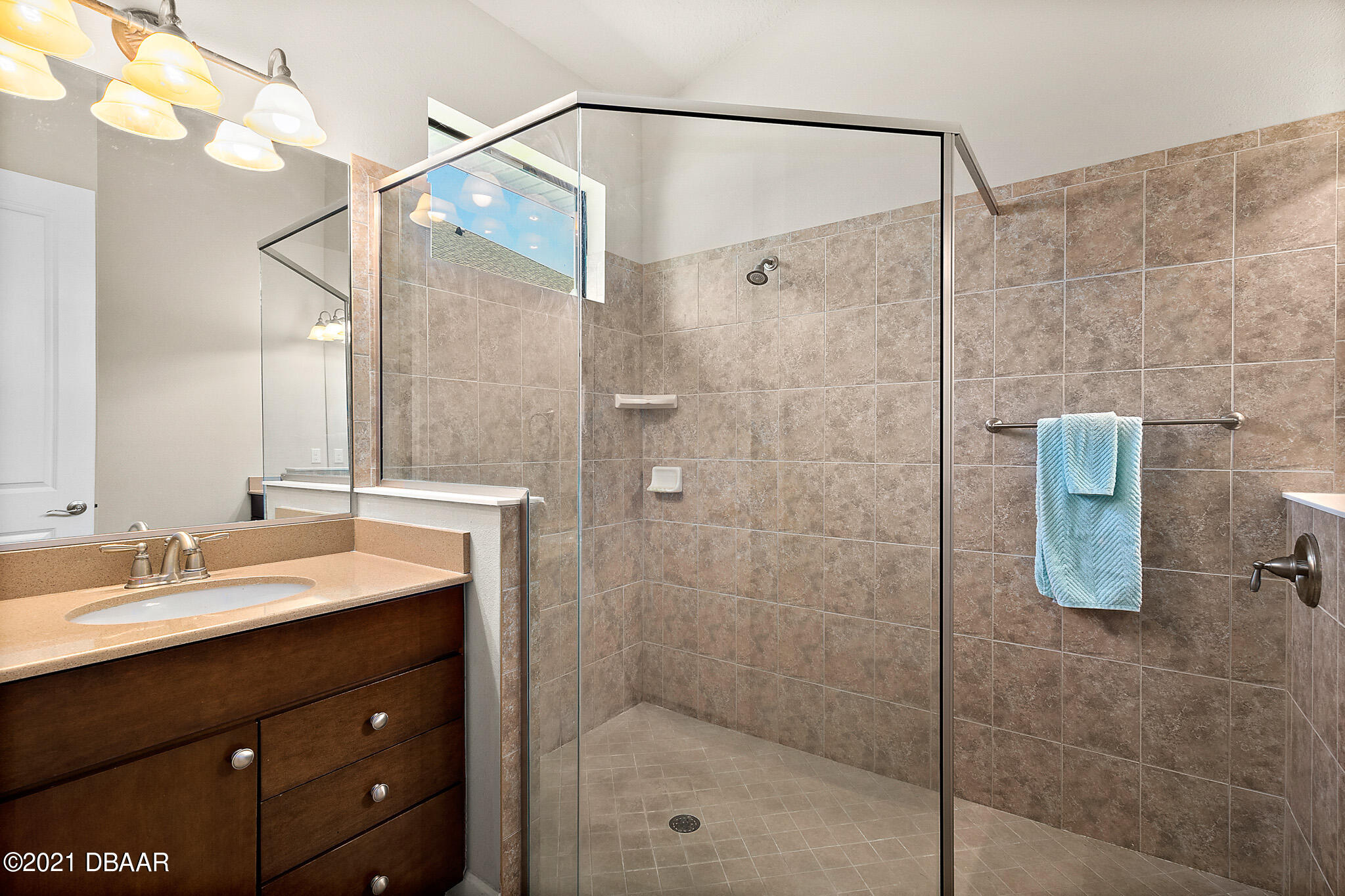 667 Elk River Drive Ormond Beach, FL 32174 - Photo 22 of 49 a bathroom with a sink mirror and shower