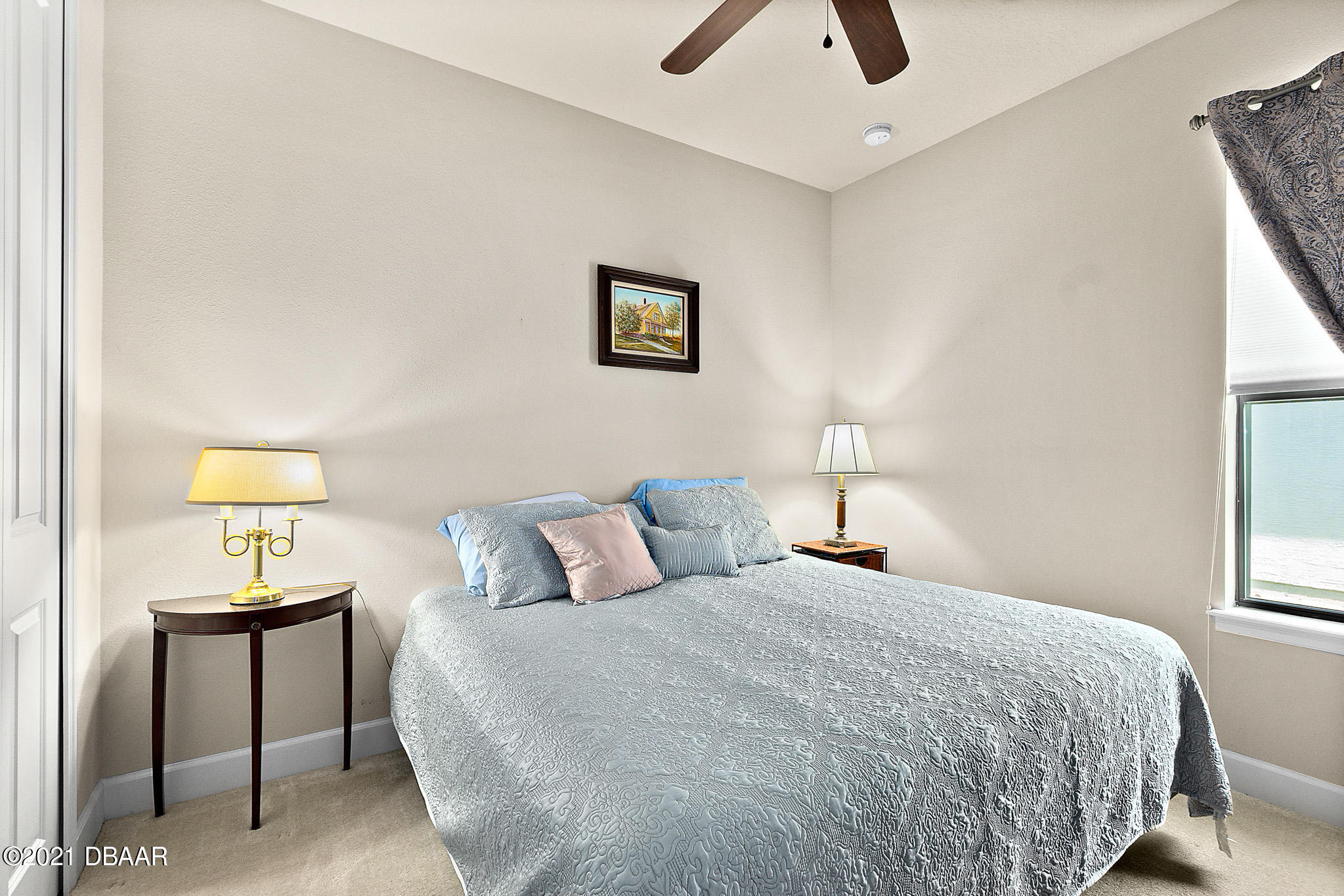 667 Elk River Drive Ormond Beach, FL 32174 - Photo 27 of 49 a bedroom with a bed and a lamp