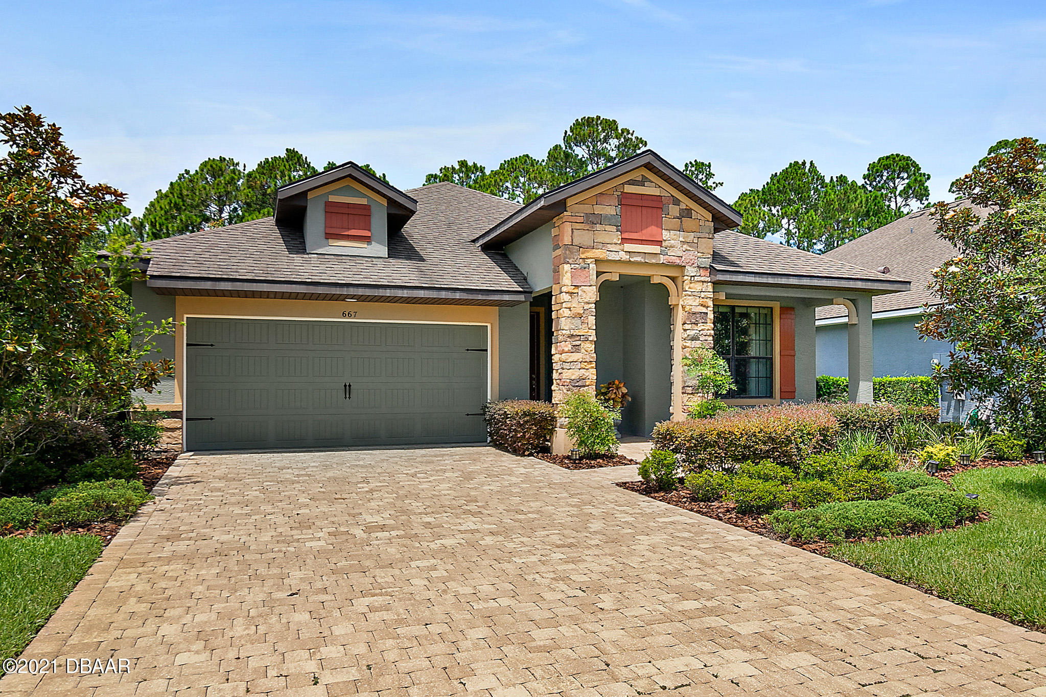 667 Elk River Drive Ormond Beach, FL 32174 - Photo 37 of 49 a front view of a house with a yard and garage
