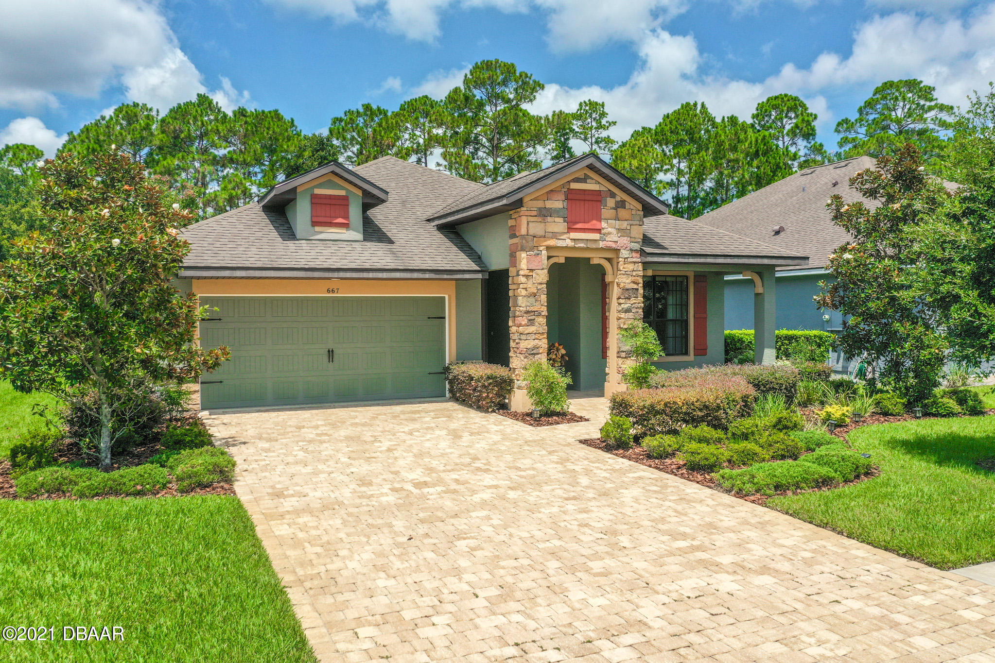 667 Elk River Drive Ormond Beach, FL 32174 - Photo 38 of 49 a front view of a house with a yard and potted plants