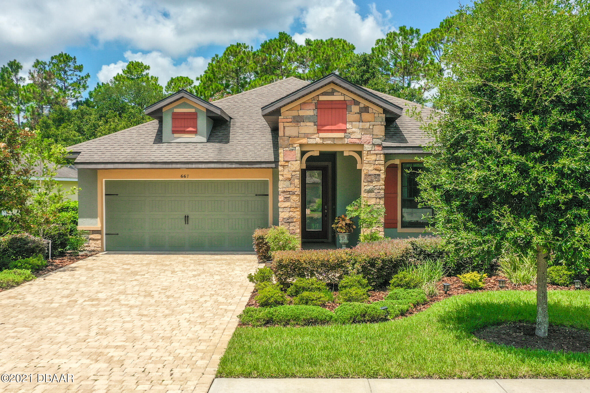 667 Elk River Drive Ormond Beach, FL 32174 - Photo 47 of 49 a front view of a house with a yard and garage