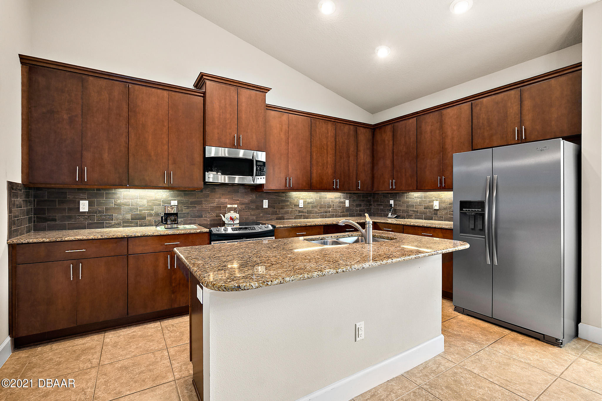 667 Elk River Drive Ormond Beach, FL 32174 - Photo 4 of 49 a kitchen with stainless steel appliances granite countertop a refrigerator stove a sink and dishwasher