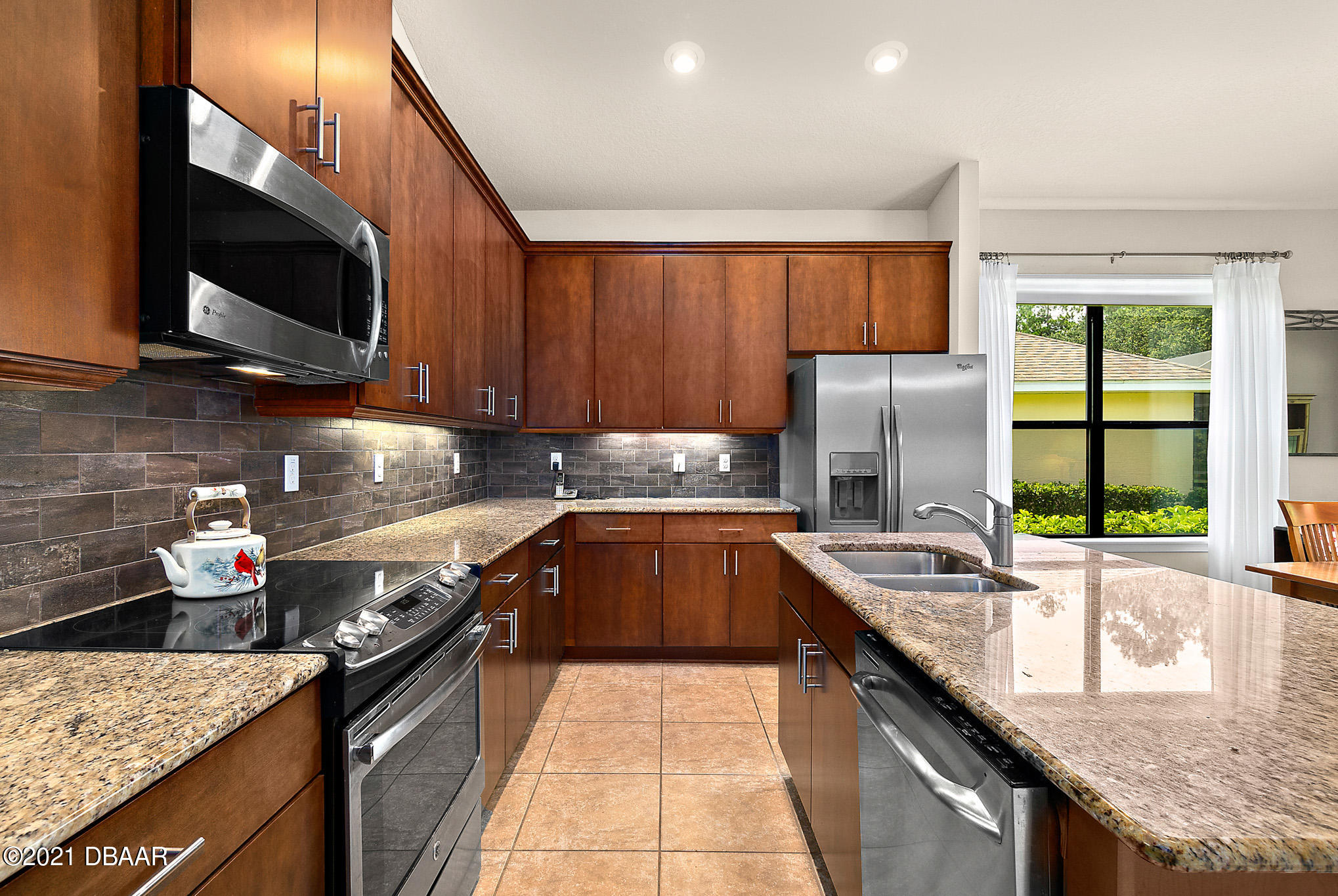 667 Elk River Drive Ormond Beach, FL 32174 - Photo 6 of 49 a kitchen with stainless steel appliances granite countertop a sink stove and refrigerator