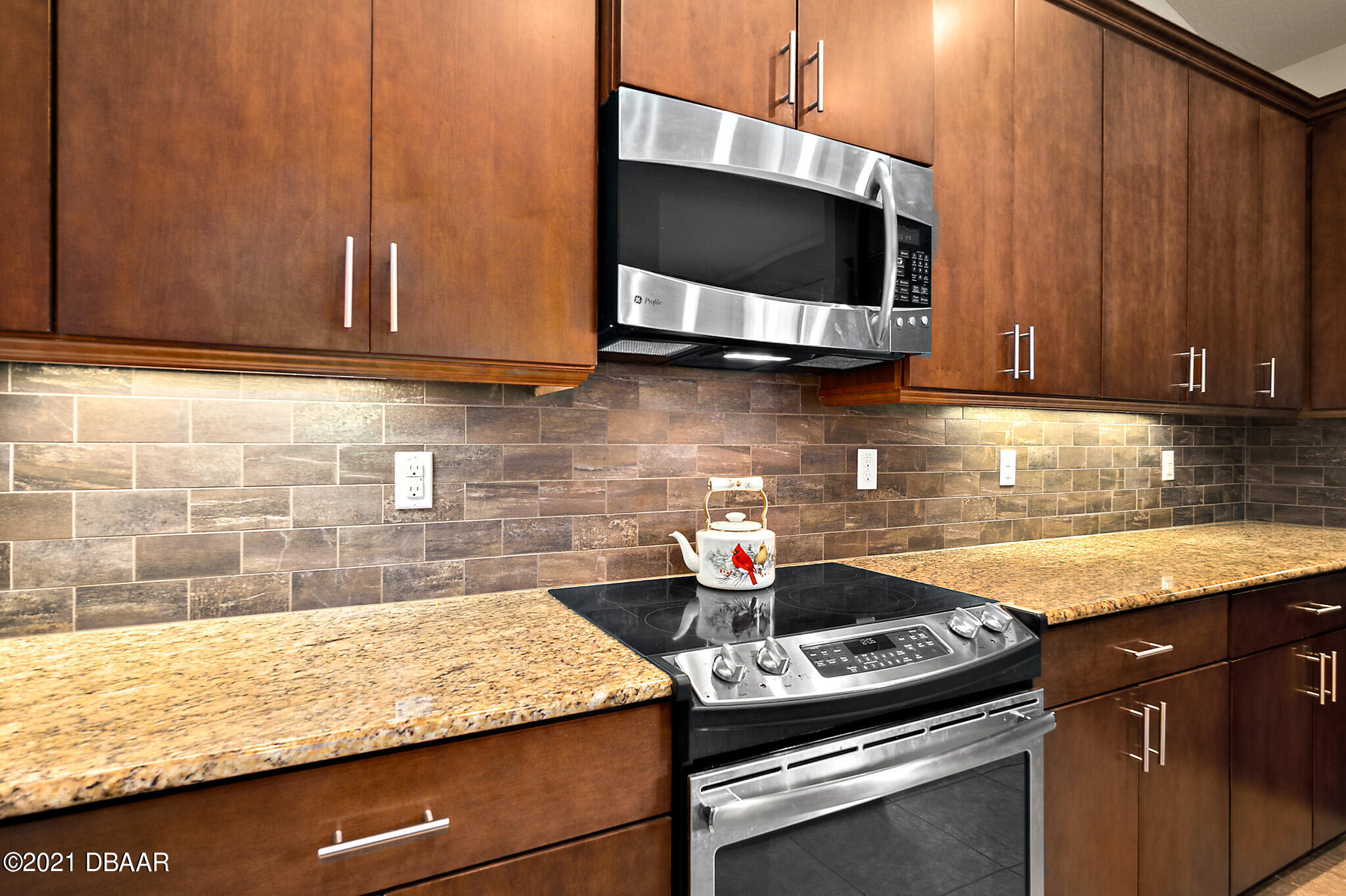 667 Elk River Drive Ormond Beach, FL 32174 - Photo 7 of 49 a kitchen with a stove and a microwave