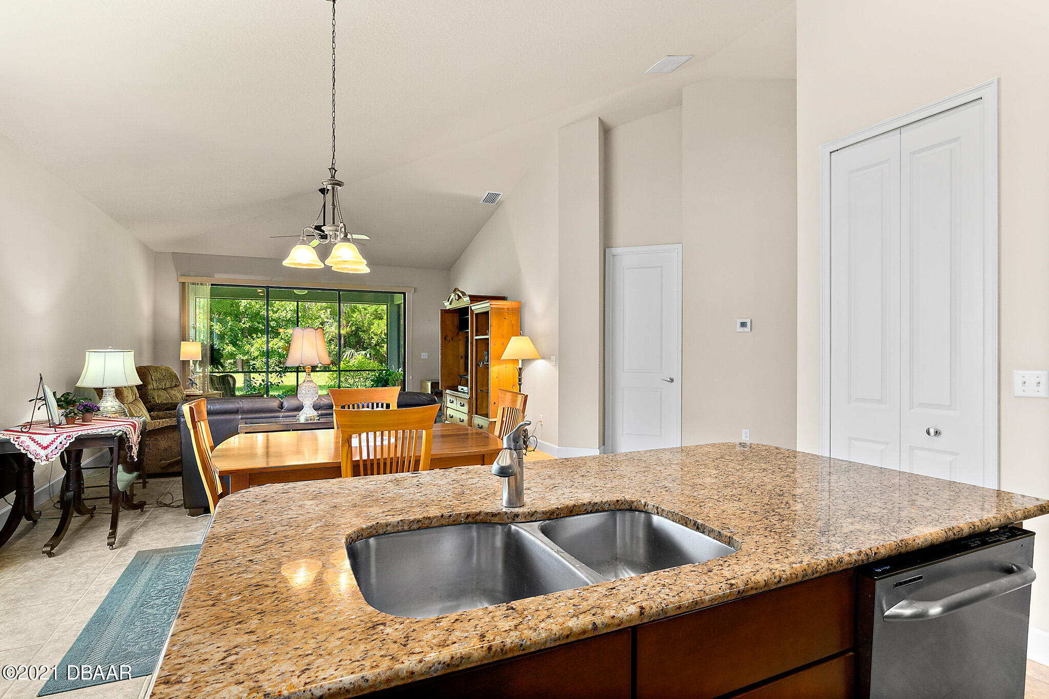 667 Elk River Drive Ormond Beach, FL 32174 - Photo 8 of 49 a kitchen with sink refrigerator and window