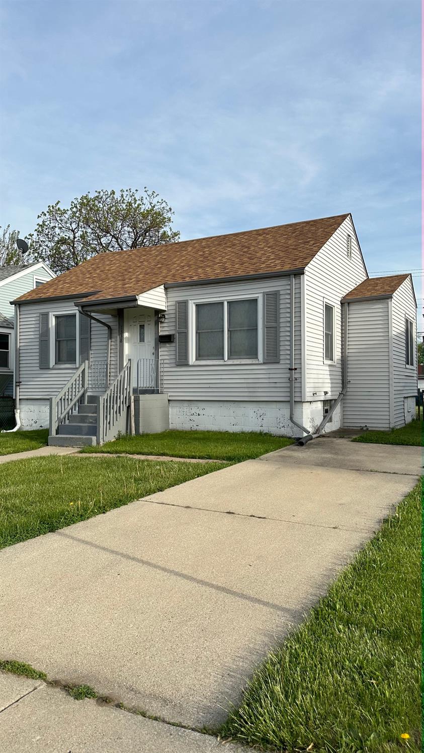 1338 Hoffman Street Hammond, IN 46327 - Photo 1 of 15 a front view of house with yard and green space