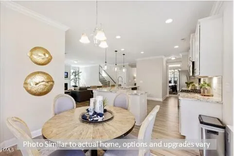 a dining room with chandelier fan and wooden floor