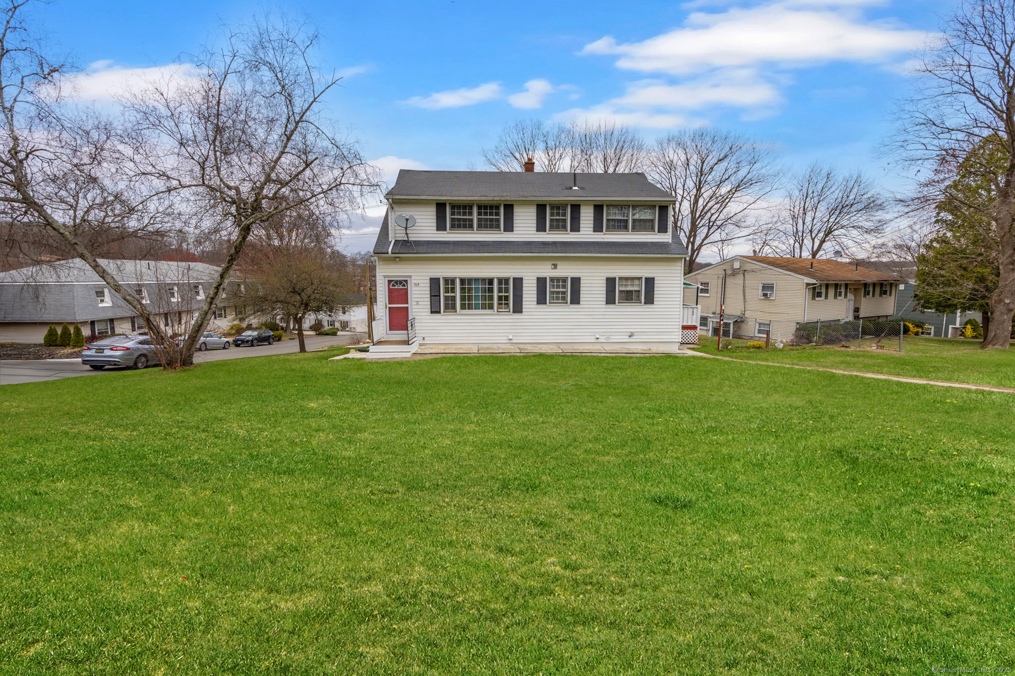 164 Deerfield Avenue Waterbury, CT 06708 - Photo 1 of 1 a view of a house with a big yard and large trees