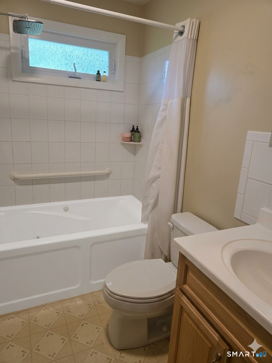 23 Ridgecrest Road Wallingford, CT 06492 - Photo 7 of 7 a white toilet sitting next to a bath tub