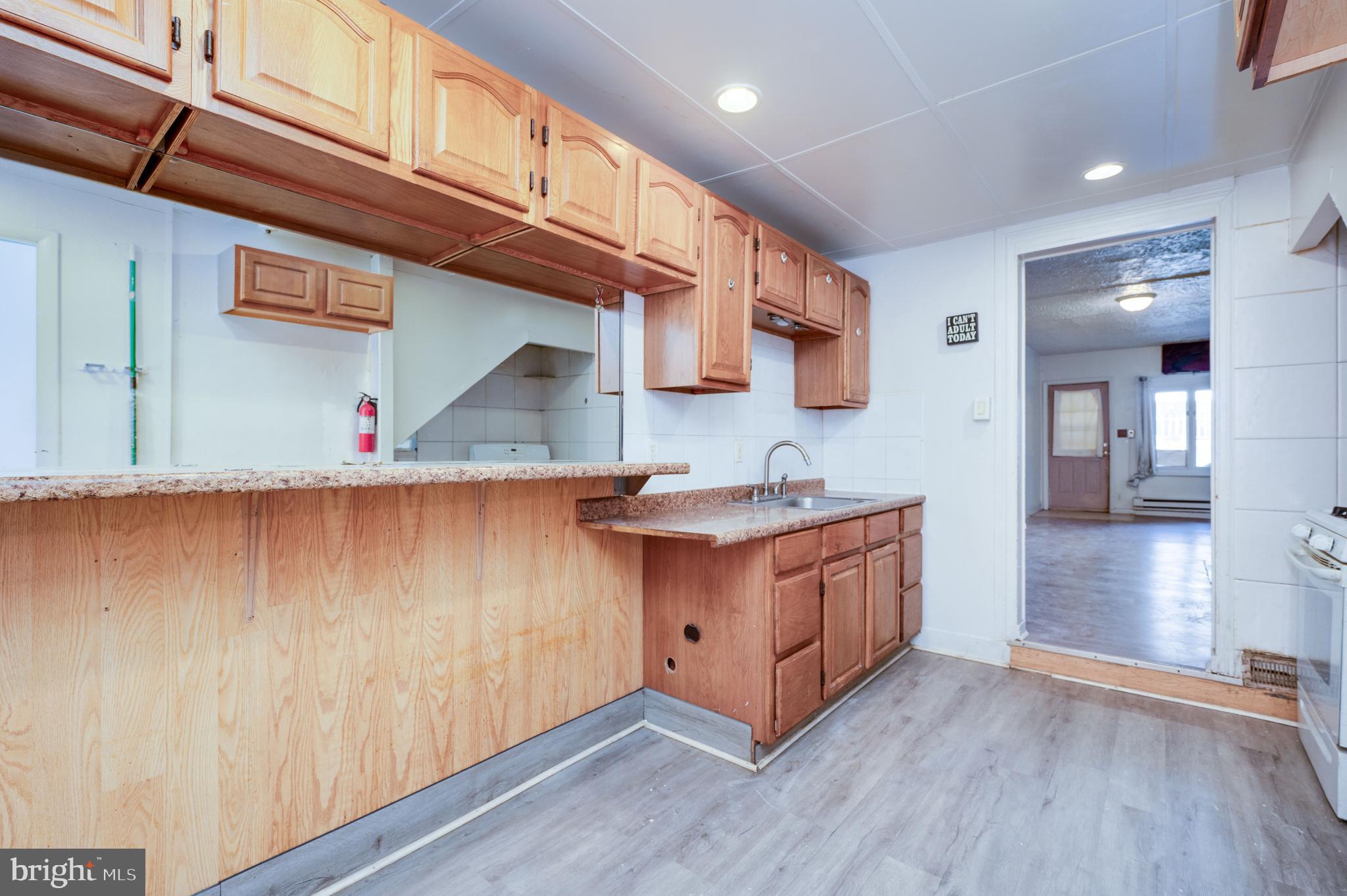 1022 Birch Street Reading, PA 19604 - Photo 14 of 32 a kitchen with stainless steel appliances granite countertop a sink a stove and a wooden floors