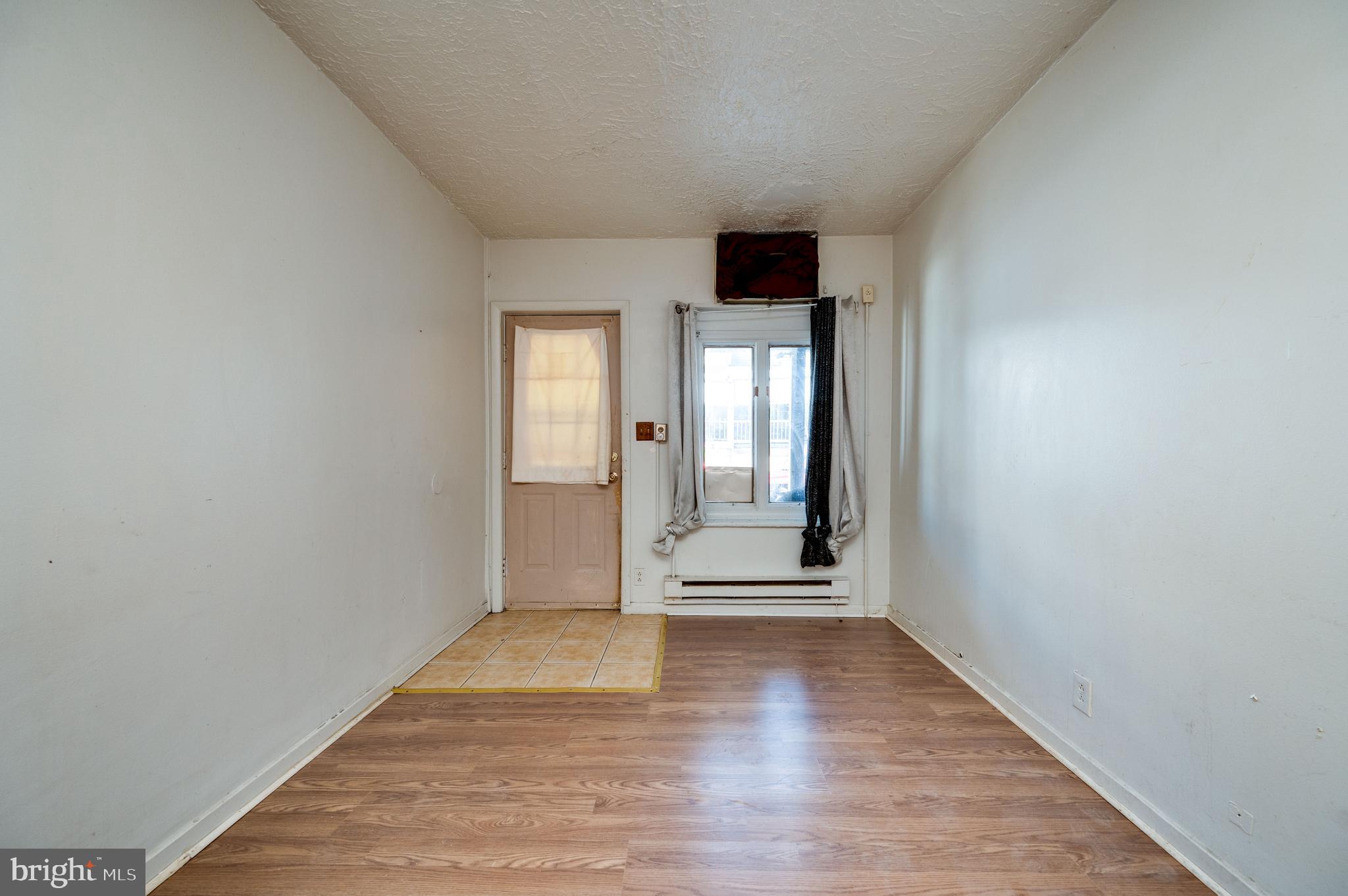 1022 Birch Street Reading, PA 19604 - Photo 16 of 32 a view of an empty room with wooden floor and a window