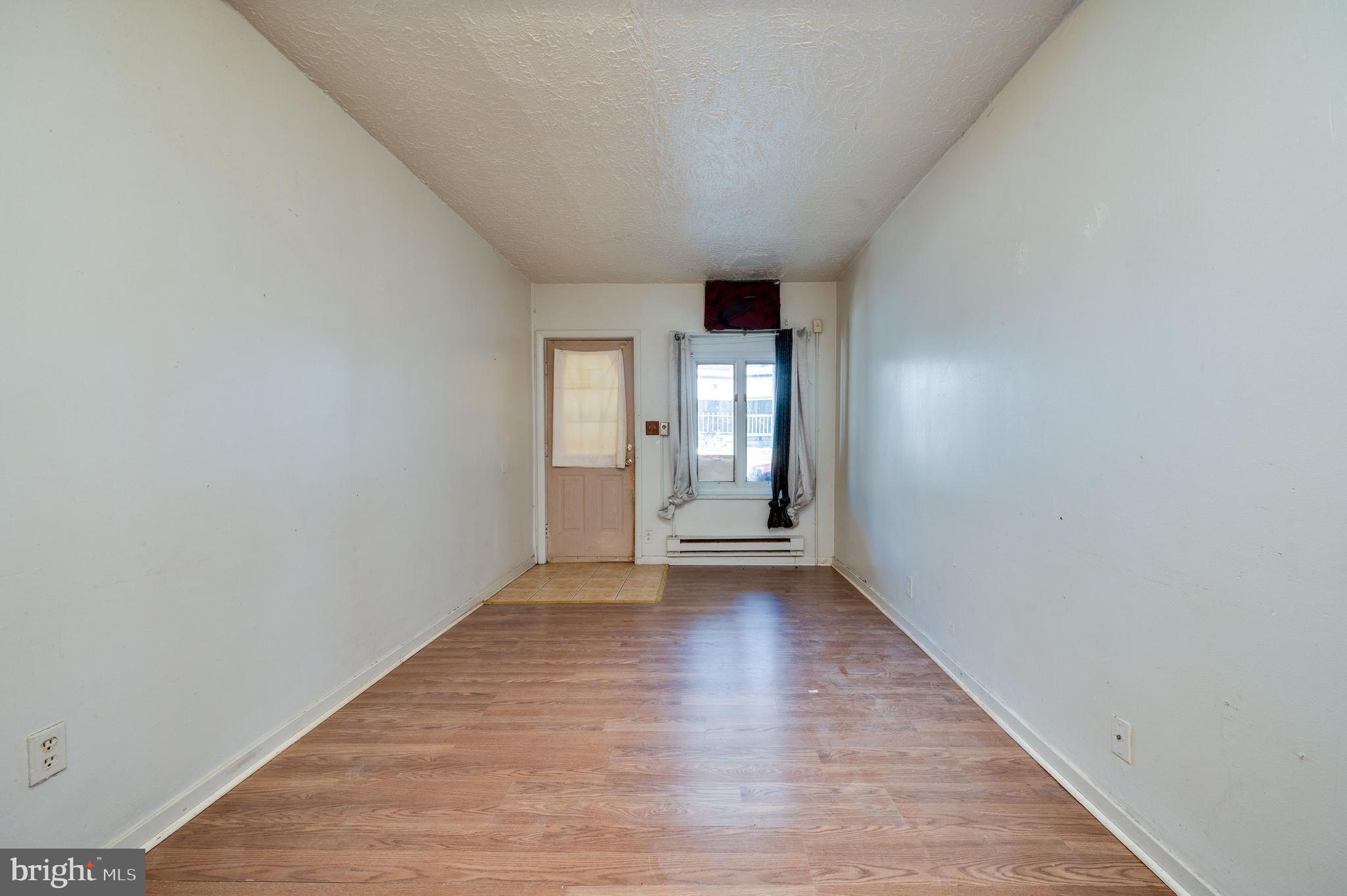 1022 Birch Street Reading, PA 19604 - Photo 21 of 32 a view of an empty room with window and wooden floor