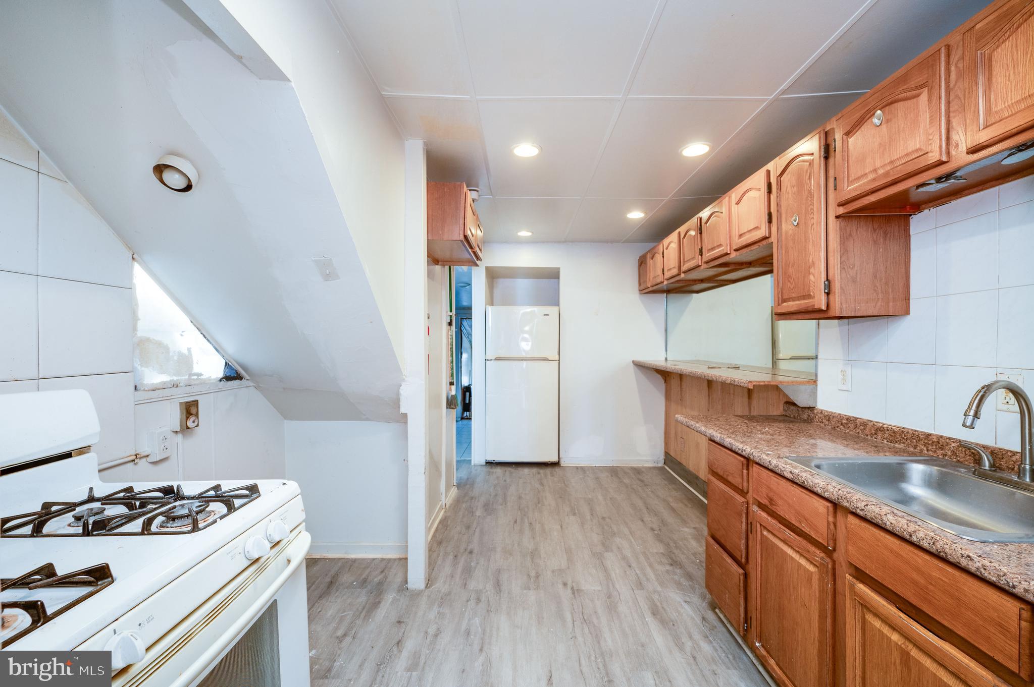 1022 Birch Street Reading, PA 19604 - Photo 6 of 32 a kitchen with stainless steel appliances granite countertop a sink stove and refrigerator