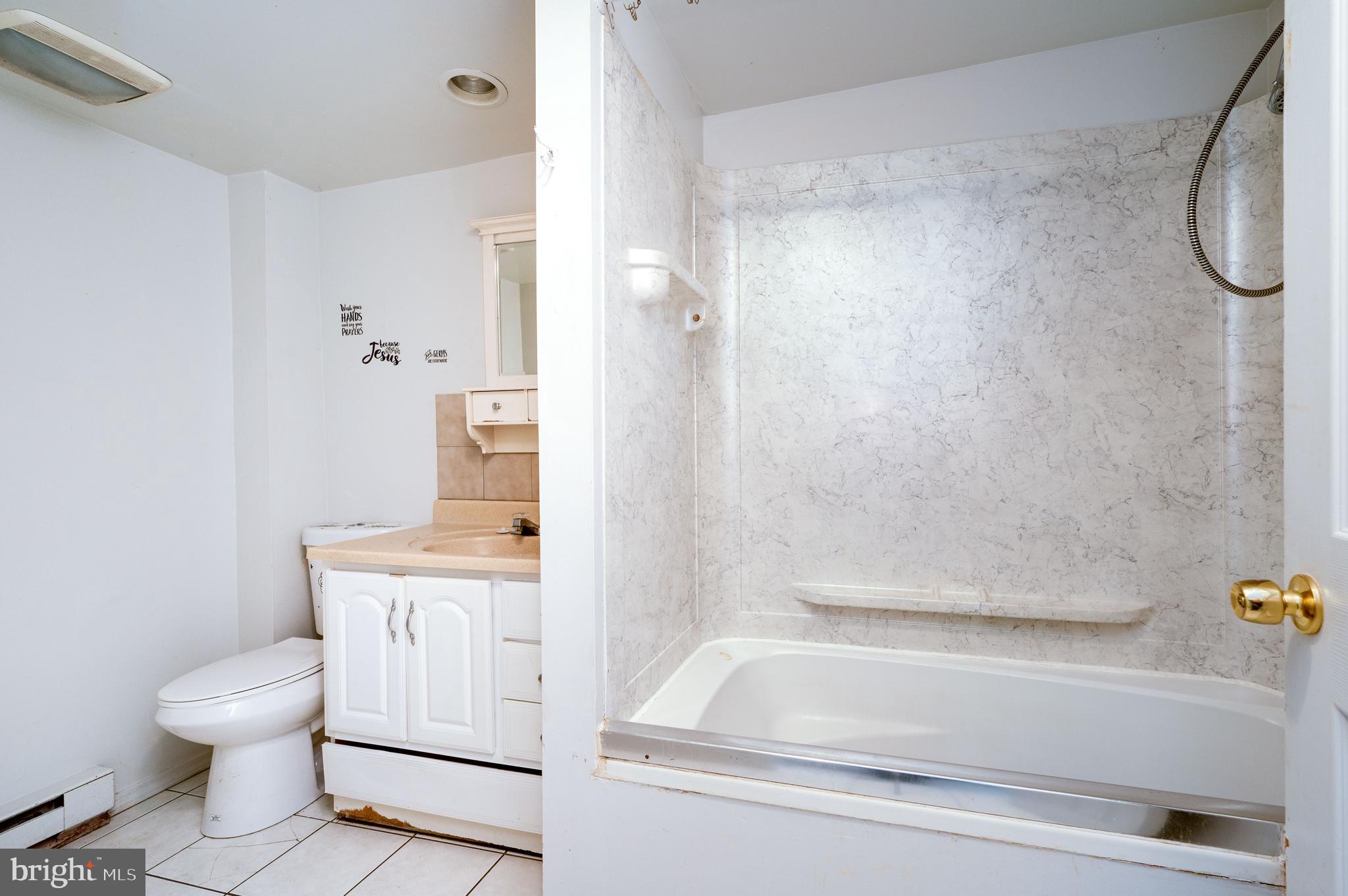 1022 Birch Street Reading, PA 19604 - Photo 7 of 32 a bathroom with a sink a toilet and shower