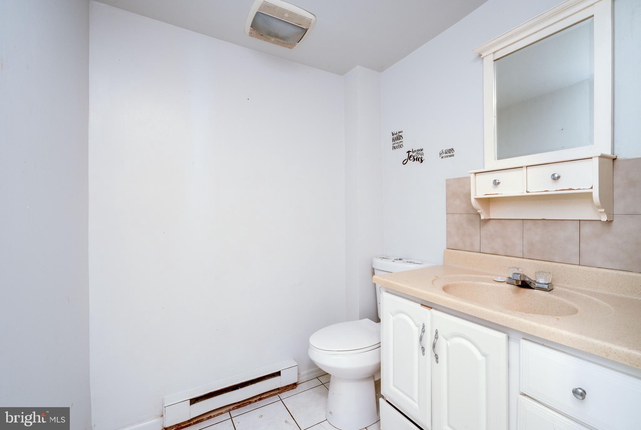 1022 Birch Street Reading, PA 19604 - Photo 8 of 32 a bathroom with a sink a toilet and mirror