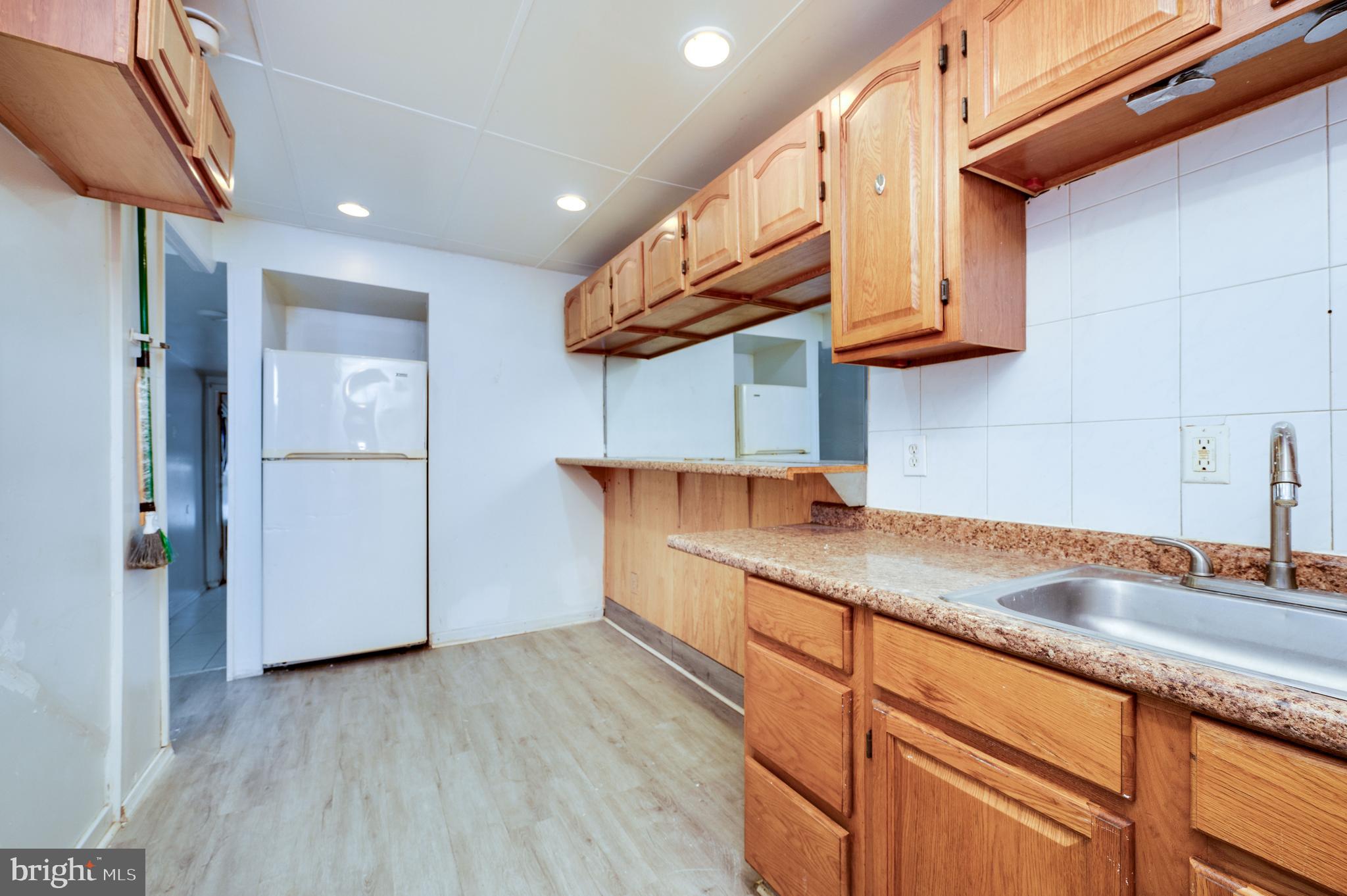 1022 Birch Street Reading, PA 19604 - Photo 9 of 32 a kitchen with stainless steel appliances granite countertop a sink a refrigerator and a stove