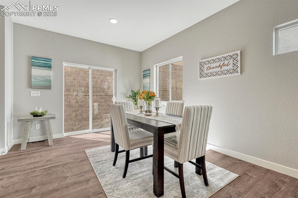 175 Terrace Drive Colorado Springs, CO 80906 - Photo 15 of 50 a view of a dining room with furniture window and wooden floor