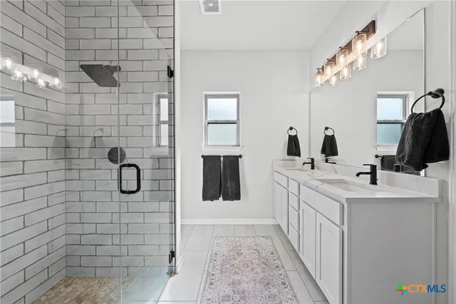 a bathroom with a double vanity sink a mirror and vanity