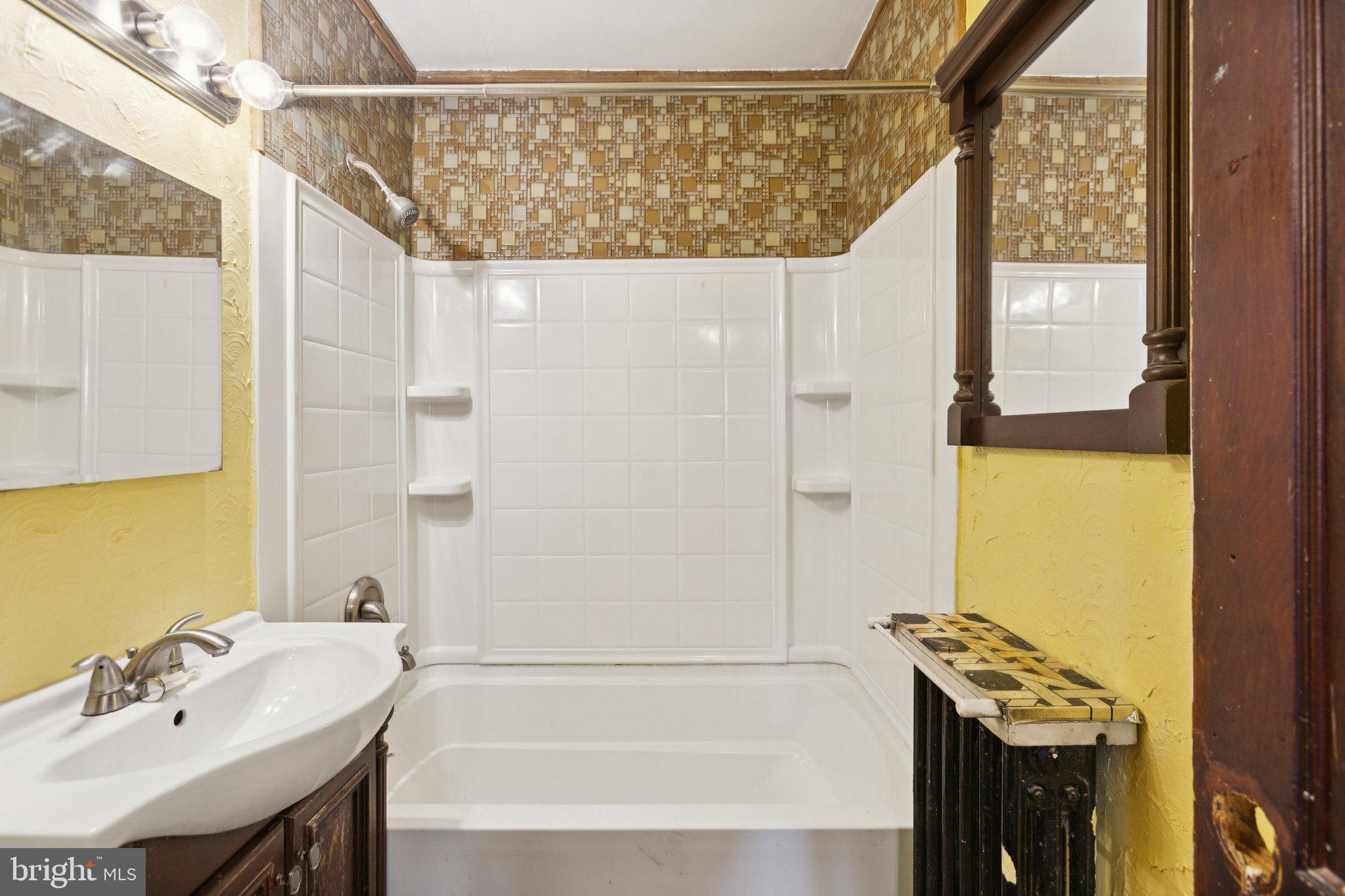 1633 R Street Southeast Washington, DC 20020 - Photo 17 of 44 a bathroom with a sink a mirror and a bathtub