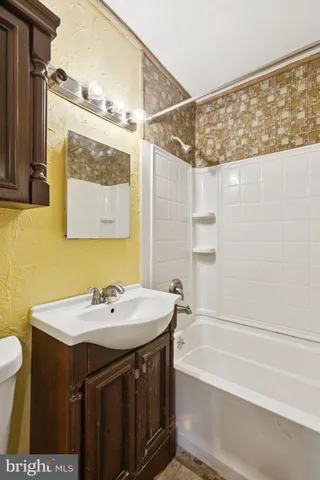 a bathroom with a glass shower door and a toilet
