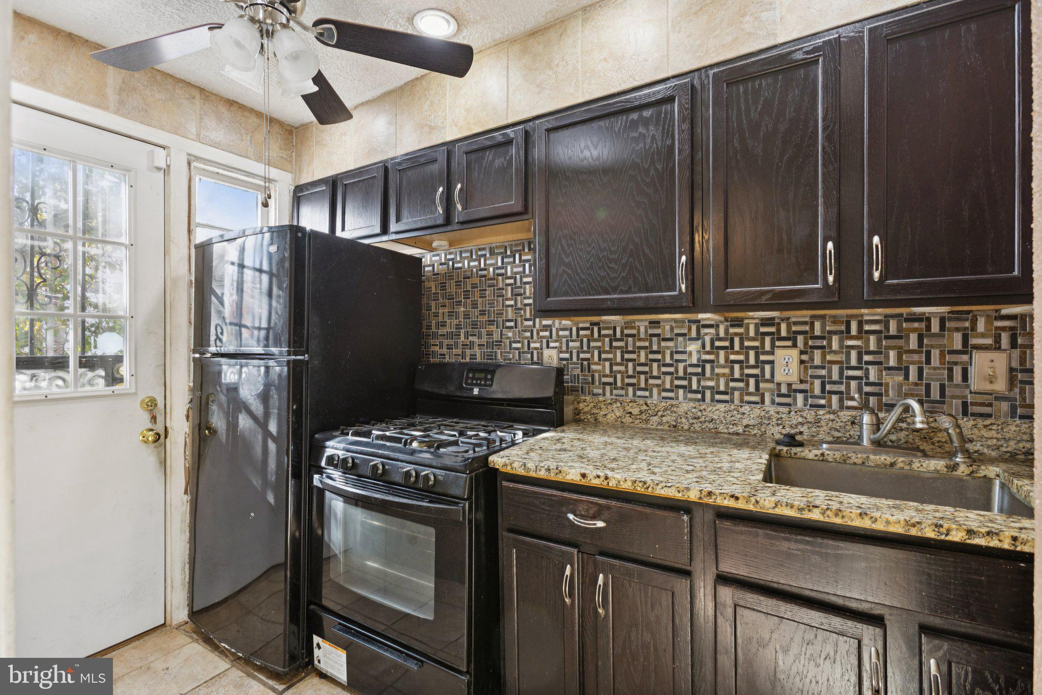 1633 R Street Southeast Washington, DC 20020 - Photo 27 of 44 a kitchen with granite countertop a refrigerator stove and sink