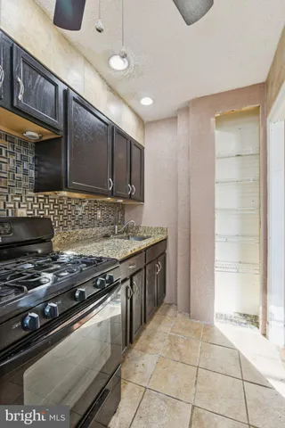 a kitchen with a stove and cabinets