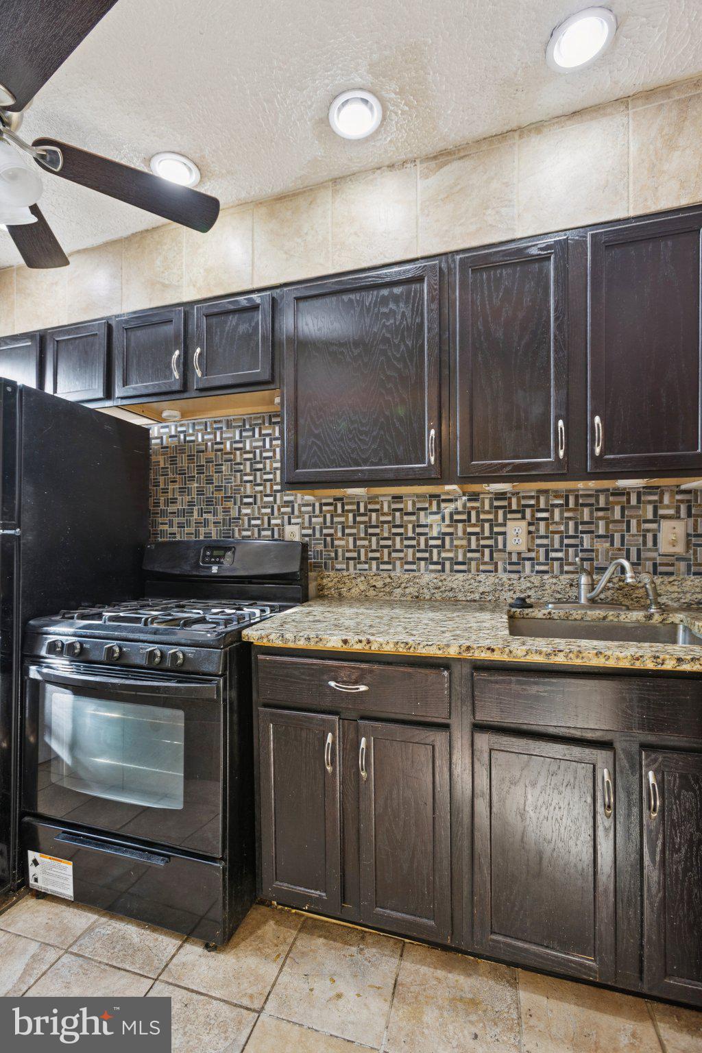 1633 R Street Southeast Washington, DC 20020 - Photo 30 of 44 a kitchen with a stove and cabinets