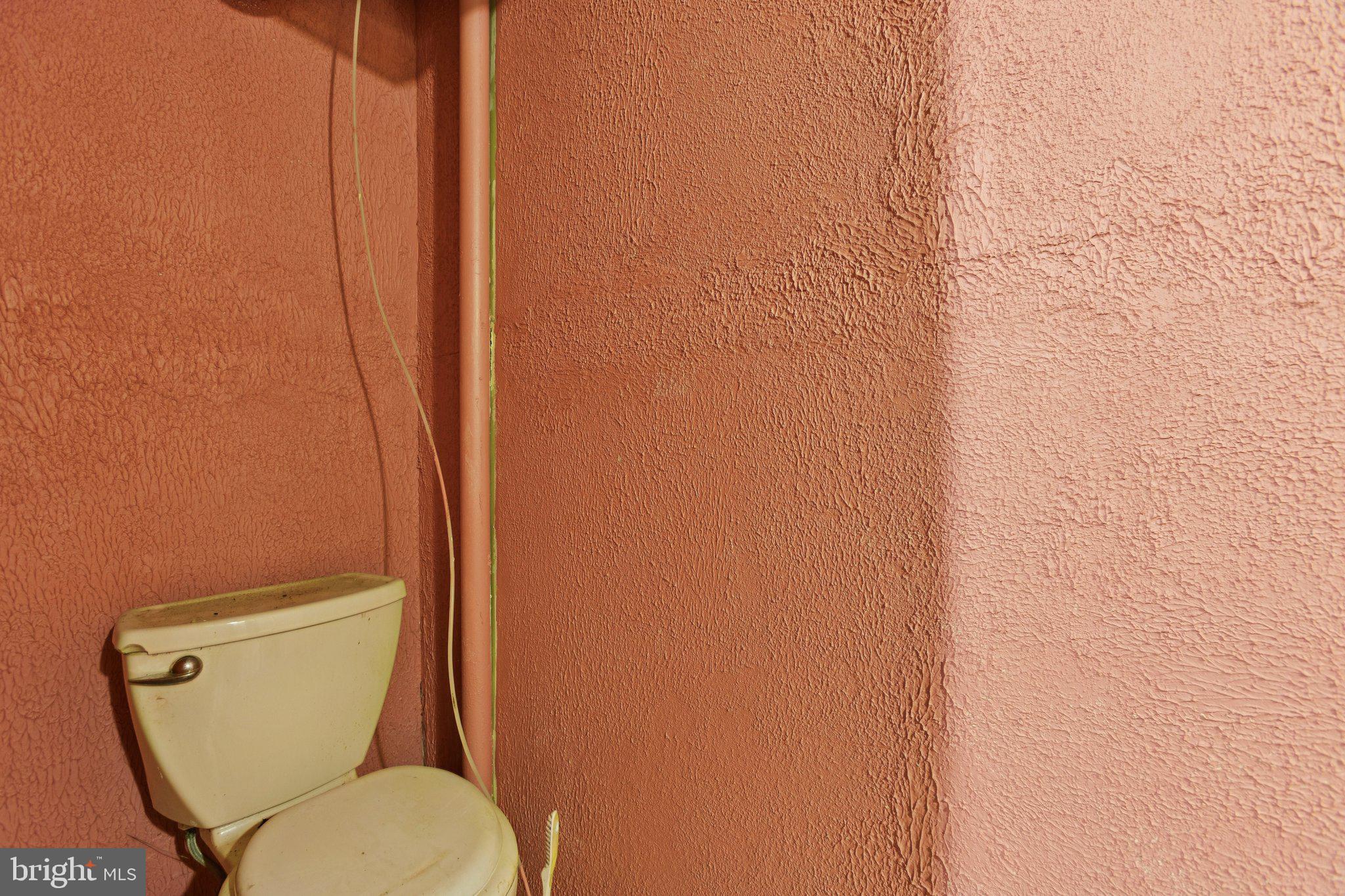 1633 R Street Southeast Washington, DC 20020 - Photo 31 of 44 a toilet sitting in a bathroom next to a white wall