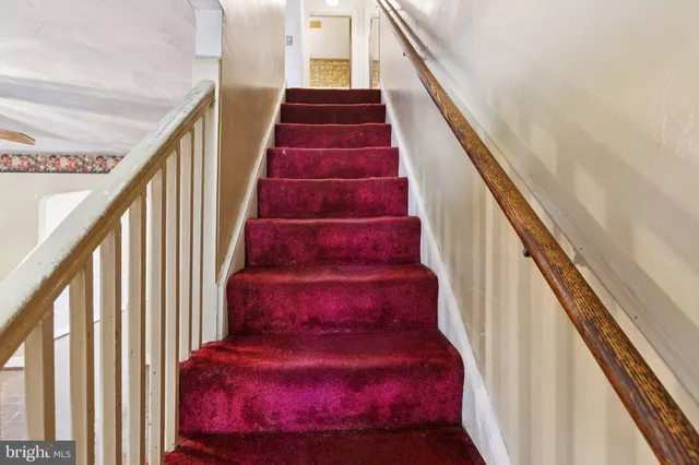 a view of a hallway with a ceiling fan