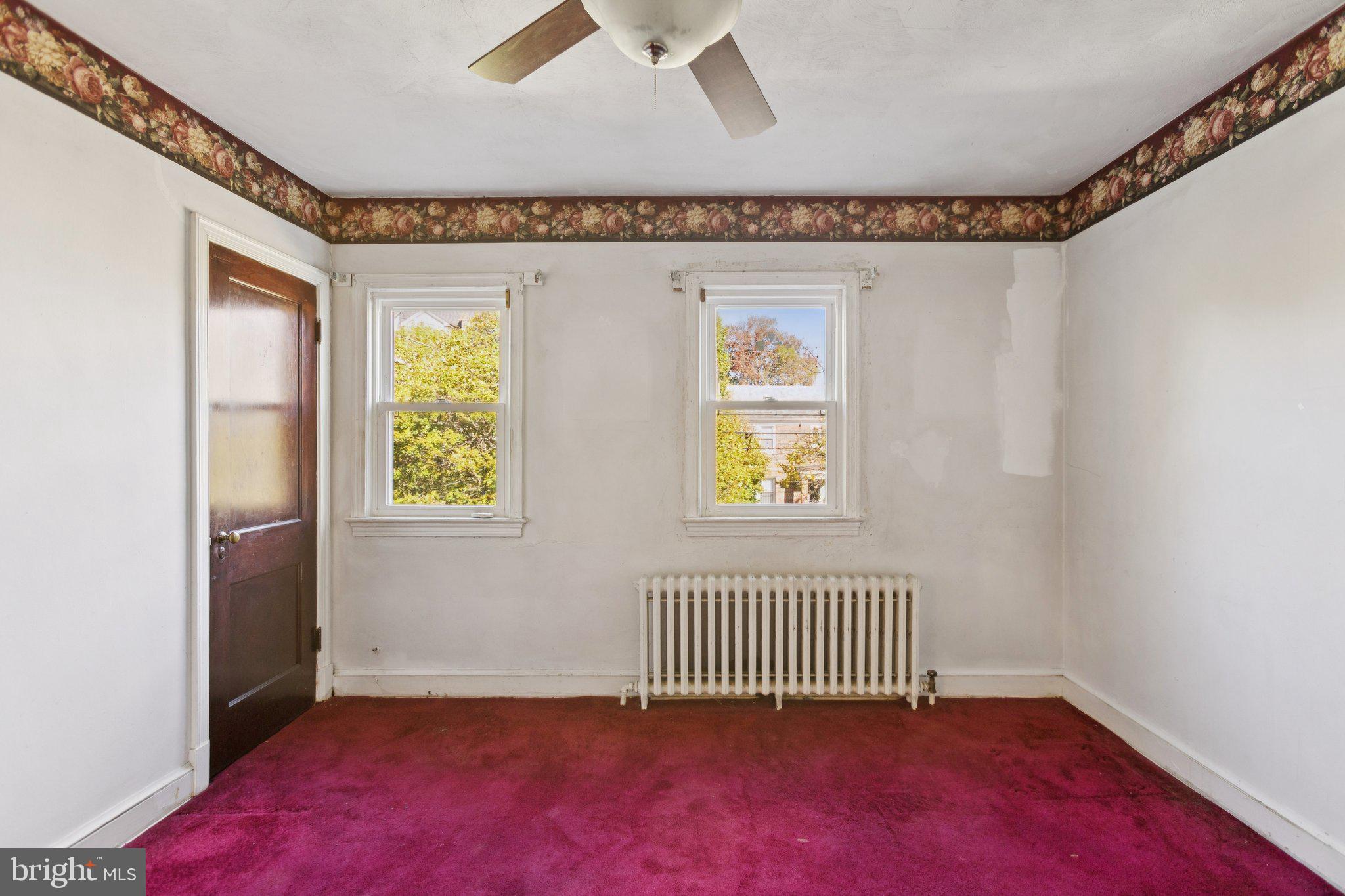 1633 R Street Southeast Washington, DC 20020 - Photo 9 of 44 an empty room with a window and wooden floor