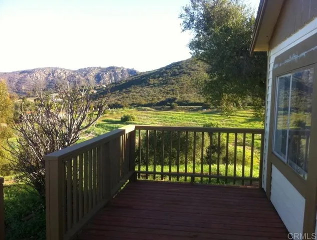 a view of wooden balcony with a lake view