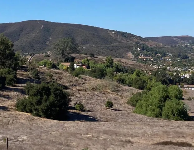 an aerial view of mountain with residential houses and trees