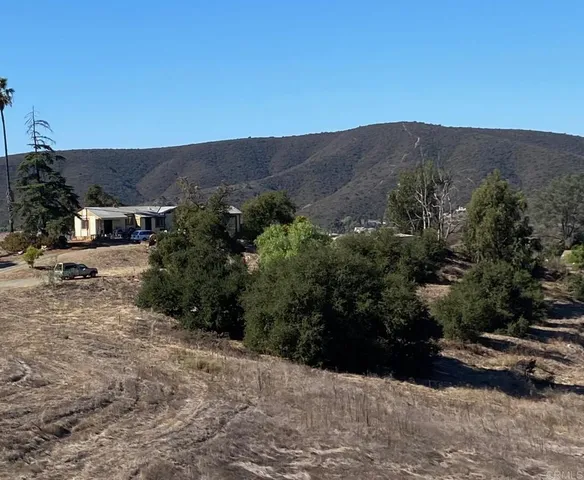 a view of a dry yard with mountain view